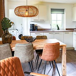Spacious kitchen with dining table in Holiday Home Citta Romana, Hellevoetsluis, ideal for self-catering during your stay.