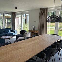 Spacious living room of the detached house in Hellevoetsluis, South Holland, overlooking the green landscape of Voorne Putten.