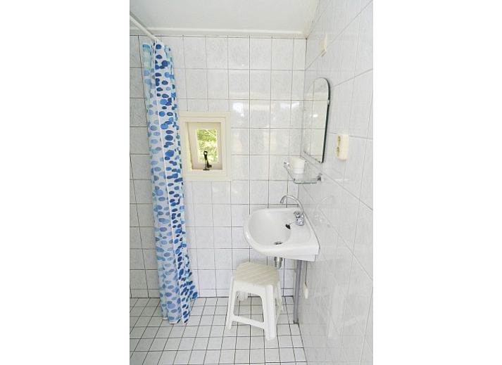 Rustic terrace at Comes well vacation home in De Cocksdorp Texel with green surroundings