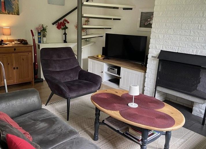 Terrace of Ferienperle vacation home in De Cocksdorp, Texel, surrounded by greenery.