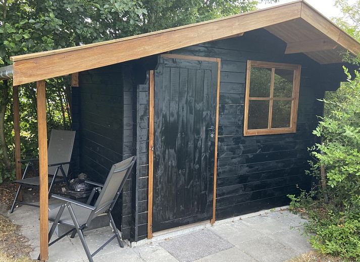 Modern kitchen in Krim 661 with sauna, Stuha, and BBQ, a bungalow in De Cocksdorp, Texel, Wadden Islands, overlooking the garden.