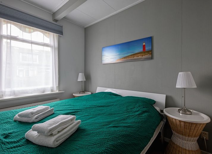 Gezellige woonkamer van Kikkertstraat 065, vakantiehuis in De Cocksdorp, Texel, met comfortabele zithoek.