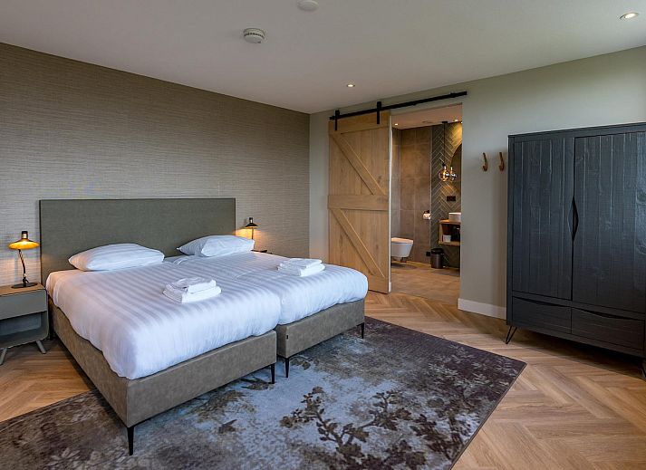 View from the living room of Princenhof 1 - 6-pers in De Cocksdorp, Texel with modern furnishings and terrace.