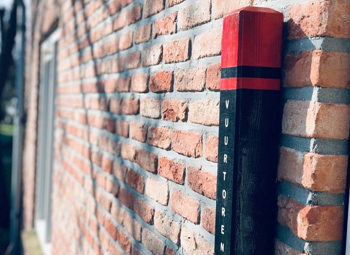 Cozy living room of Holiday home De Vuurtoren in De Cocksdorp Texel with modern furnishings.