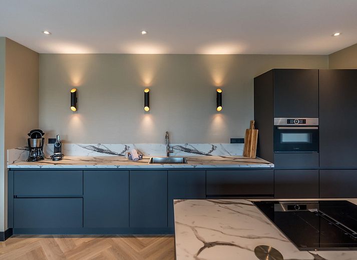 Modern living room in Princenhof 2, Texel, with comfortable seating and natural light.