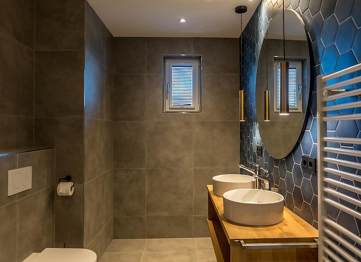 Modern living room in Princenhof 2, Texel, with comfortable seating and natural light.