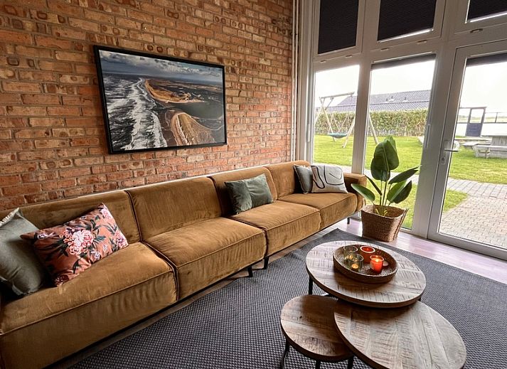 Gezellige zithoek in Noorderwind vakantiehuis, De Cocksdorp, Texel met comfortabele banken en warme inrichting.