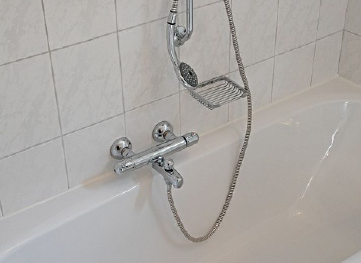 Gezellige eetkamer in Vakantiehuis Slufterduin 076, De Cocksdorp, Texel. Perfect voor familiediners op de Waddeneilanden.