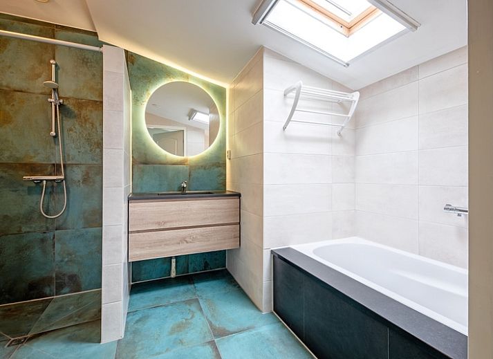 Cozy living room in Holiday home Slufterhoek 180, De Cocksdorp, Texel with lots of light and views of nature.