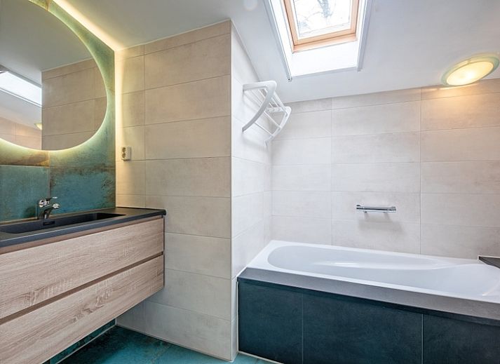 Comfortable sitting area in Holiday home Slufterhoek 180, De Cocksdorp, Texel with modern furnishings and cozy atmosphere.