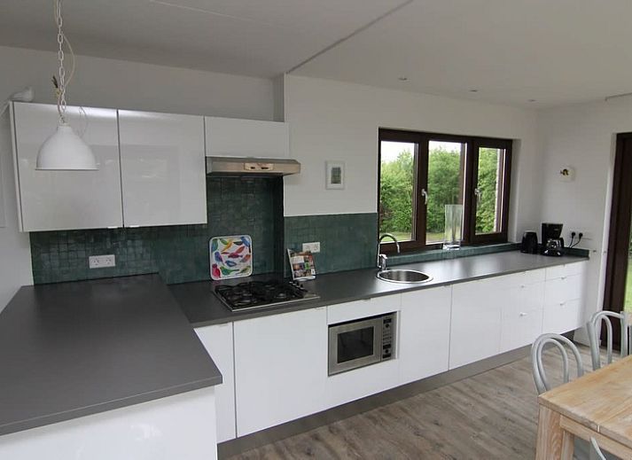 Vakantiehuis D 491 in De Cocksdorp, Texel, omgeven door groene natuur, met een uitnodigend terras voor een ontspannen verblijf op de Waddeneilanden.