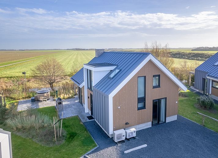 Freistehendes Haus in De Cocksdorp auf Texel, ein Ferienhaus mit moderner Architektur und einer einladenden Terrasse auf dem Lande.