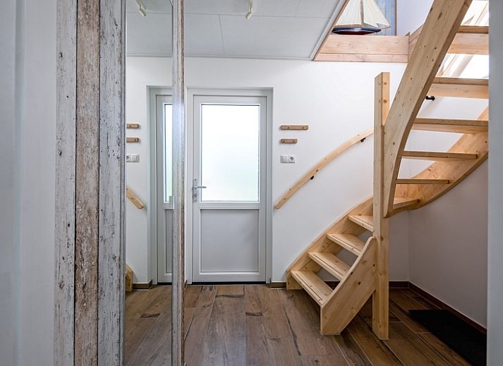 Lichte woonkamer van Vakantiehuis Slufterhoek 158 in De Cocksdorp, Texel, met moderne inrichting en uitzicht op de tuin.