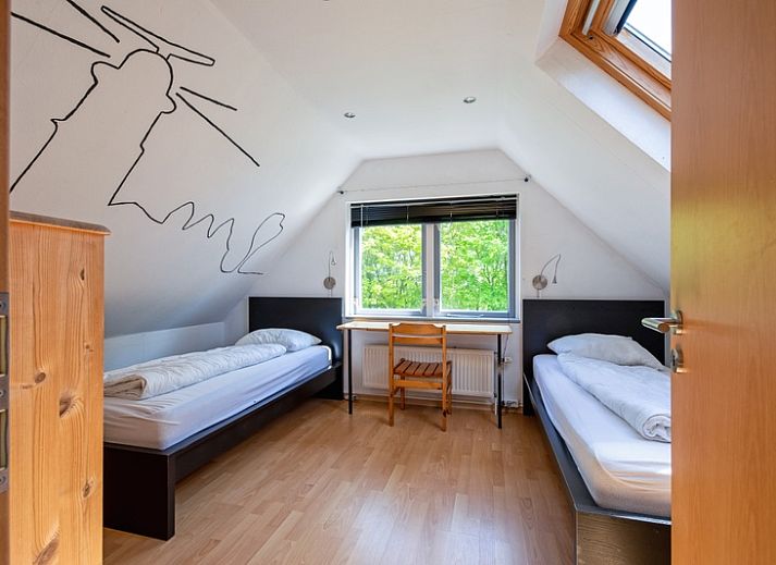 Lichte woonkamer van Vakantiehuis Slufterhoek 158 in De Cocksdorp, Texel, met moderne inrichting en uitzicht op de tuin.