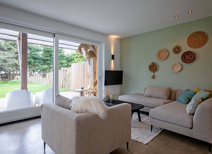 Vakantiehuis Brakzand in De Cocksdorp op Texel met houten terras en groene tuin, ideaal voor een ontspannen verblijf op de Waddeneilanden.