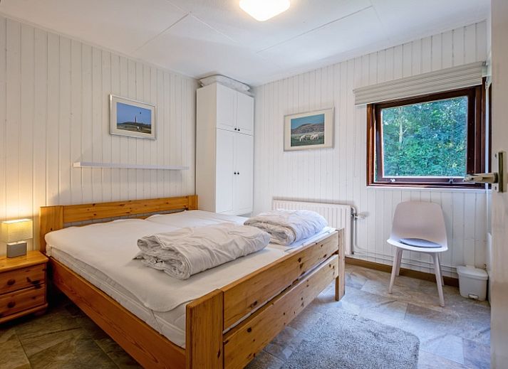 Gemuetliches Wohnzimmer des Ferienhauses Slufterduin 092 in De Cocksdorp, Texel mit bequemen Sofas und viel Tageslicht.