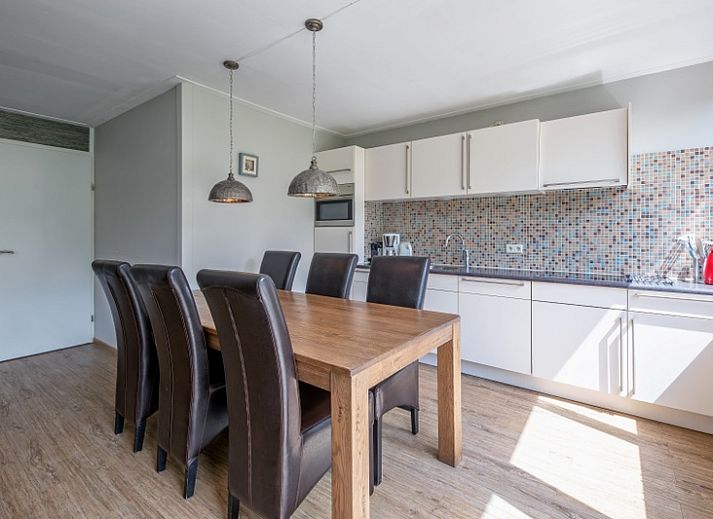 Cozy living room of Holiday home Slufterhoek 132 in De Cocksdorp, Texel with comfortable sofas and views of nature.