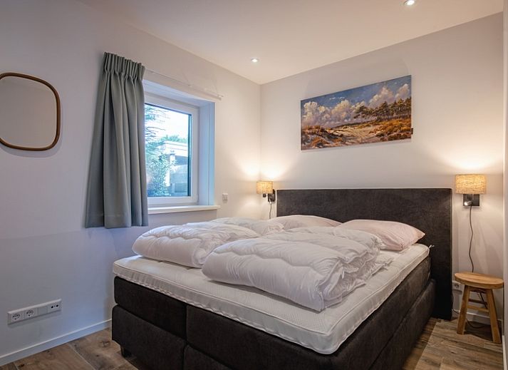 Gezellige woonkamer van Vakantiehuis Slufterhoek 104 in De Cocksdorp, Texel met comfortabele zitplaatsen en sfeervolle inrichting.