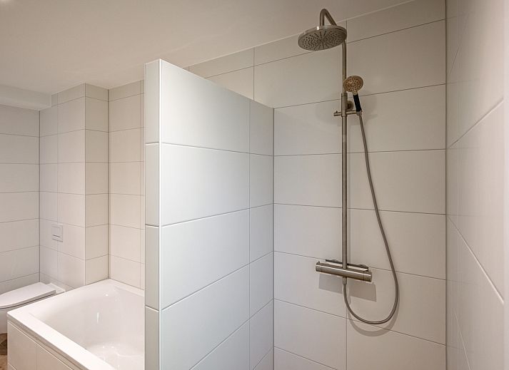 Gezellige woonkamer van Vakantiehuis Slufterhoek 104 in De Cocksdorp, Texel met comfortabele zitplaatsen en sfeervolle inrichting.