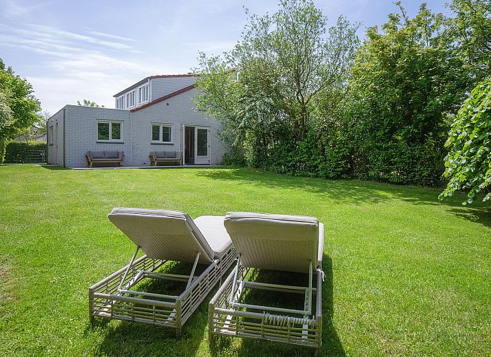 Gemuetliches Schlafzimmer im Ferienhaus 49 - Krim 698 in De Cocksdorp, Texel, mit bequemem Bett und Tageslicht durch grosse Fenster.