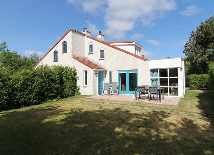 Vakantiehuis D 617 in De Cocksdorp, Texel, biedt een charmante buitenkant met tuinpad en groene omgeving op de Waddeneilanden.