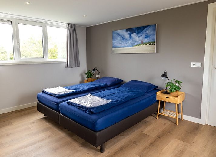 Vakantiehuis A 109 in De Cocksdorp, Texel, omgeven door groene natuur en blauwe lucht, ideaal voor een ontspannen verblijf op de Waddeneilanden.