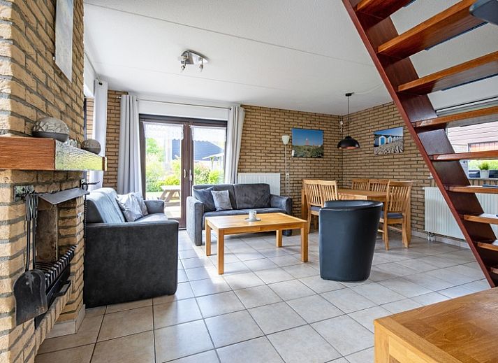 Vacation home A 309 in De Cocksdorp, Texel, offers a charming exterior with green garden and modern architecture on the Wadden Islands.