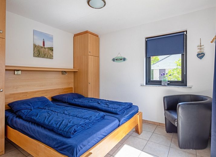 Vacation home A 309 in De Cocksdorp, Texel, offers a charming outdoor space with green garden and modern architecture on the Wadden Islands.