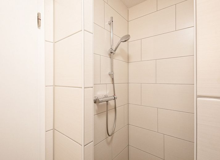 Vakantiehuis A 141 in De Cocksdorp, Texel biedt een serene tuin en uitnodigende entree, ideaal voor een ontspannen verblijf op de Waddeneilanden.