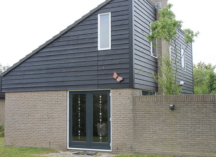 Vakantiehuis A 267 in De Cocksdorp, Texel, biedt een moderne buitenkant met houten gevels, ideaal voor een ontspannen verblijf op de Waddeneilanden.