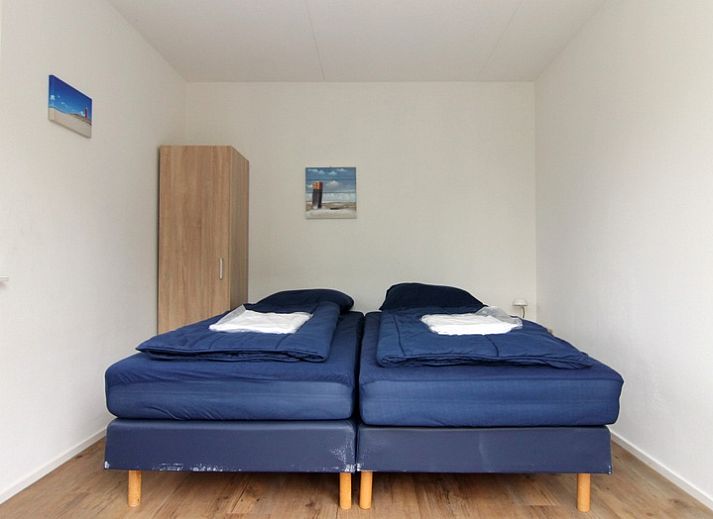 Vakantiehuis A 287 in De Cocksdorp, Texel biedt een charmant verblijf op de Waddeneilanden met een rustieke buitenkant en groene omgeving.