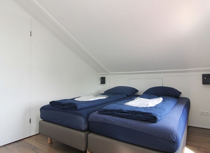 Das Ferienhaus D 489 in De Cocksdorp, Texel, bietet eine charmante Unterkunft mit einem sonnigen Garten und traditioneller Architektur auf den Watteninseln.