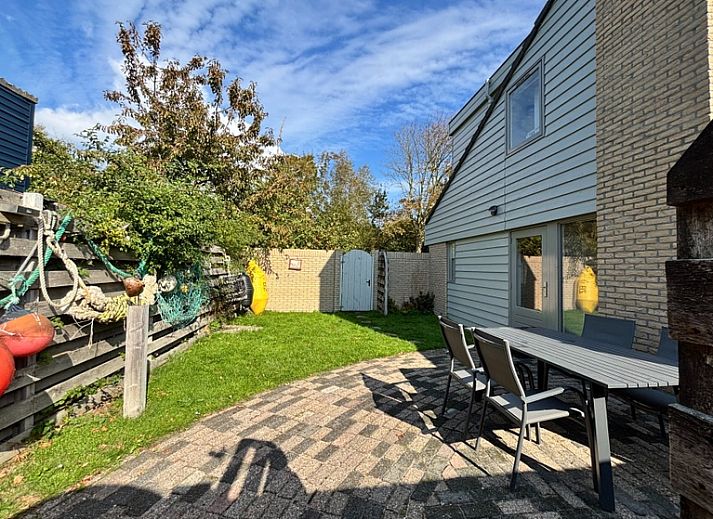 Relax in Holiday home B 011, a modern vacation home in De Cocksdorp, Texel, surrounded by green nature and an inviting terrace.