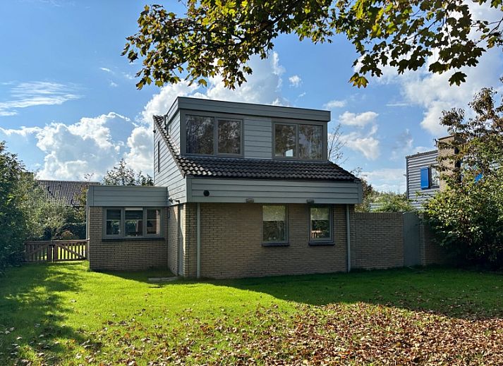 Relax in Holiday home B 011, a modern vacation home in De Cocksdorp, Texel, surrounded by green nature and an inviting terrace.