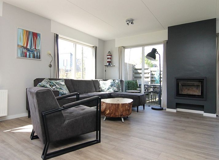 Relax in Holiday home B 011, a modern vacation home in De Cocksdorp, Texel, surrounded by green nature and an inviting terrace.