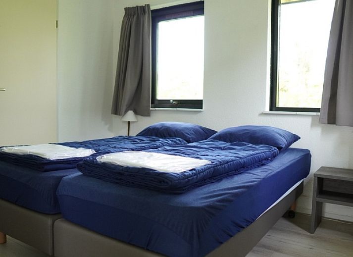 Vakantiehuis B 031 in De Cocksdorp, Texel biedt een moderne buitenkant met groene tuin, ideaal voor een ontspannen verblijf op de Waddeneilanden.