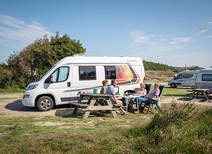 Spacious setup at Sluftervallei Comfort camping site C1, Texel with caravan and picnic table.
