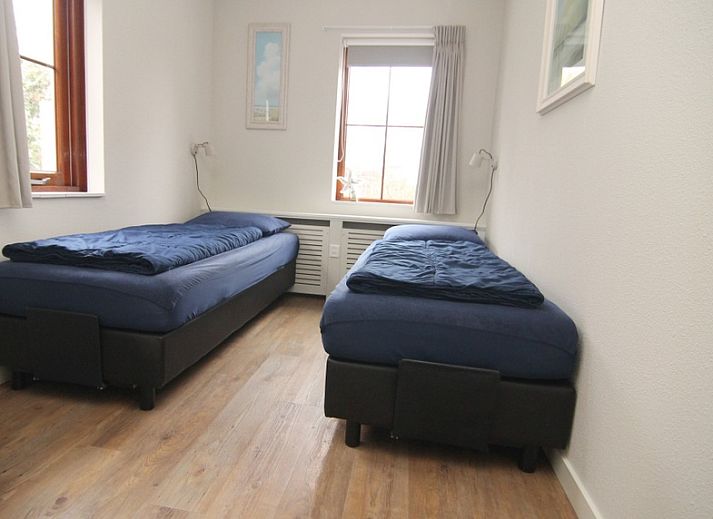 Vakantiehuis E 539, een charmant verblijf in De Cocksdorp, Texel, met uitnodigend terras en groene omgeving op de Waddeneilanden.