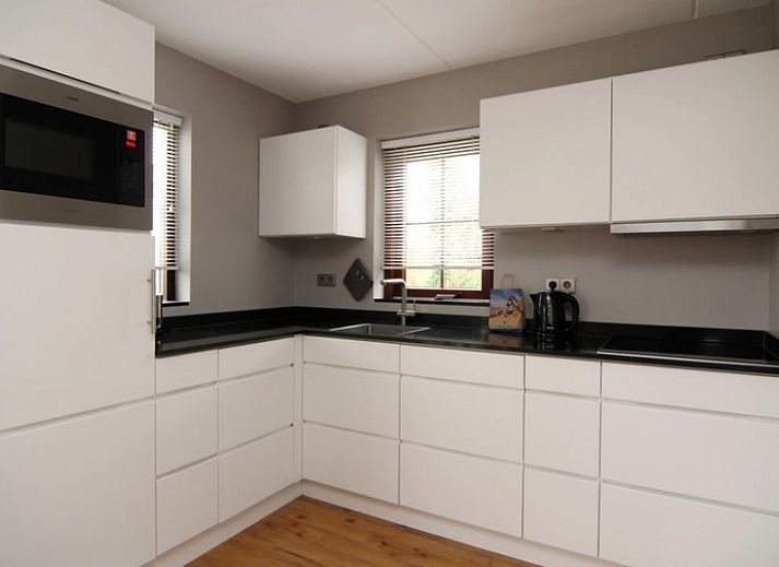 Vakantiehuis F 455 in De Cocksdorp, Texel, omgeven door groene natuur en een zonnige tuin, ideaal voor een ontspannen verblijf op de Waddeneilanden.