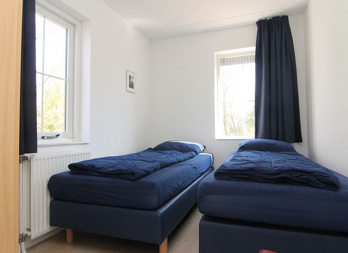 Vakantiehuis F 782 in De Cocksdorp, Texel, biedt een charmante buitenaanblik met een uitnodigende oprit en groene omgeving.