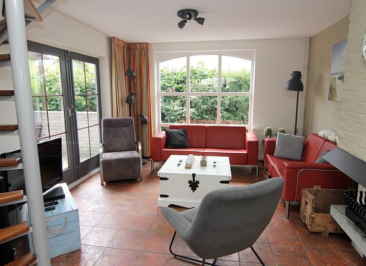 Vakantiehuis E 646 in De Cocksdorp, Texel biedt een charmante buitenruimte met groene tuin en comfortabele zitplek, ideaal voor ontspanning.
