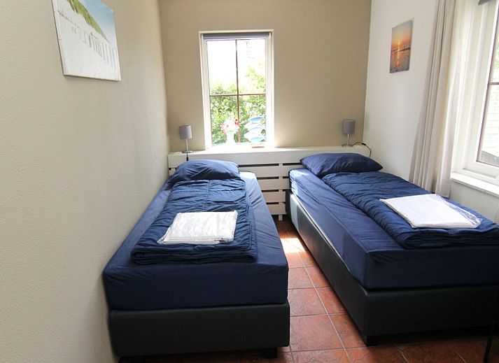 Vakantiehuis E 646 in De Cocksdorp, Texel, biedt een charmant verblijf met een zonnig terras en groene omgeving op de Waddeneilanden.