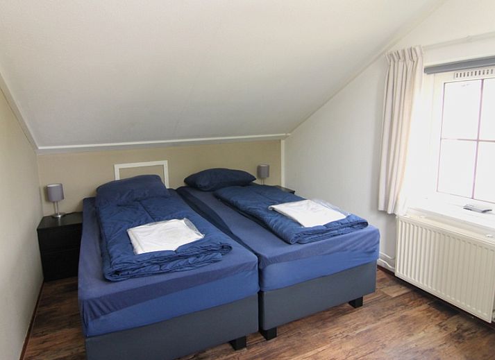 Vakantiehuis E 646 in De Cocksdorp, Texel, biedt een charmant verblijf met een zonnig terras en groene omgeving op de Waddeneilanden.