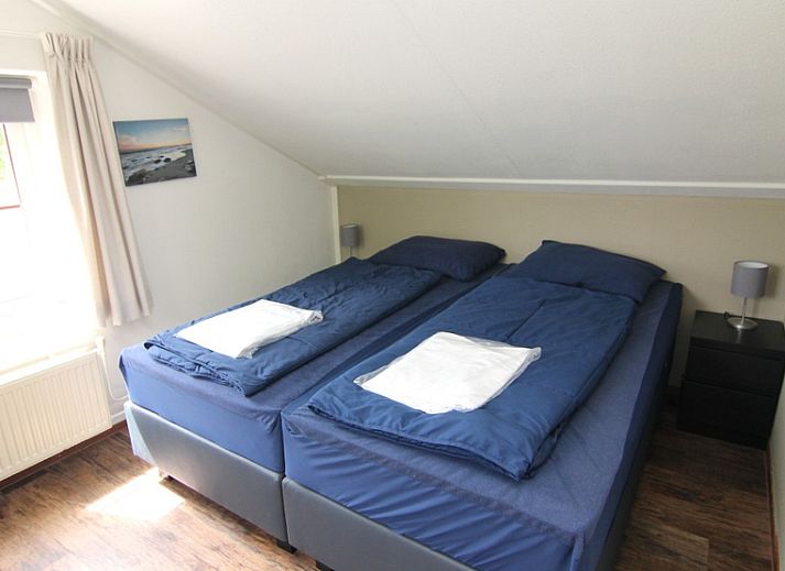 Vakantiehuis E 646 in De Cocksdorp, Texel, biedt een charmant verblijf met een zonnig terras en groene omgeving op de Waddeneilanden.