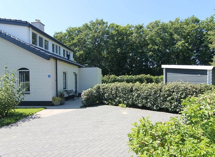 Vacation home F 776 in De Cocksdorp, Texel offers a serene outdoor space with green surroundings and spacious driveway, ideal for a relaxing stay.