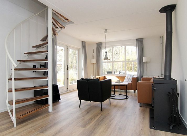 Vakantiehuis E 397 in De Cocksdorp, Texel, biedt een charmante buitenaanblik met groene omgeving voor een ontspannen eilandverblijf.