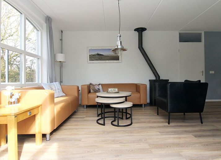 Vakantiehuis E 397 in De Cocksdorp, Texel, biedt een charmante buitenaanblik met groene omgeving voor een ontspannen eilandverblijf.