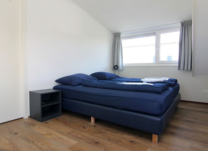 Das Ferienhaus E 511 in De Cocksdorp, Texel, bietet eine charmante Unterkunft mit einem grossen Garten und einer sonnigen Terrasse auf den schoenen Watteninseln.