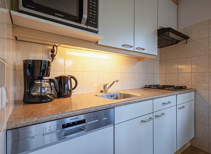 Cozy living room in Villapark Residence Texel No. 719, vacation home in De Cocksdorp, Texel with stylish sitting area and fireplace.