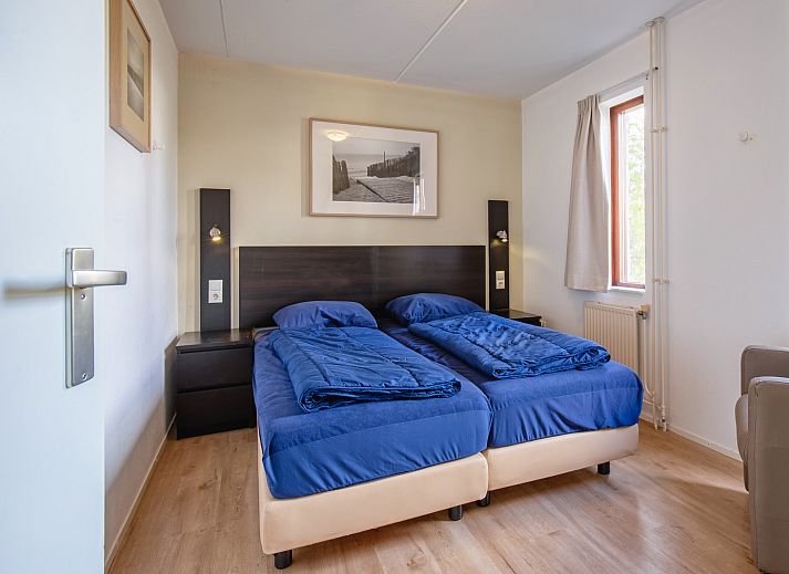 Cozy living room in Villapark Residence Texel No. 719, vacation home in De Cocksdorp, Texel with stylish sitting area and fireplace.